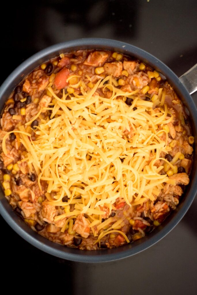 cheese added to the skillet for southwest chicken and rice skillet