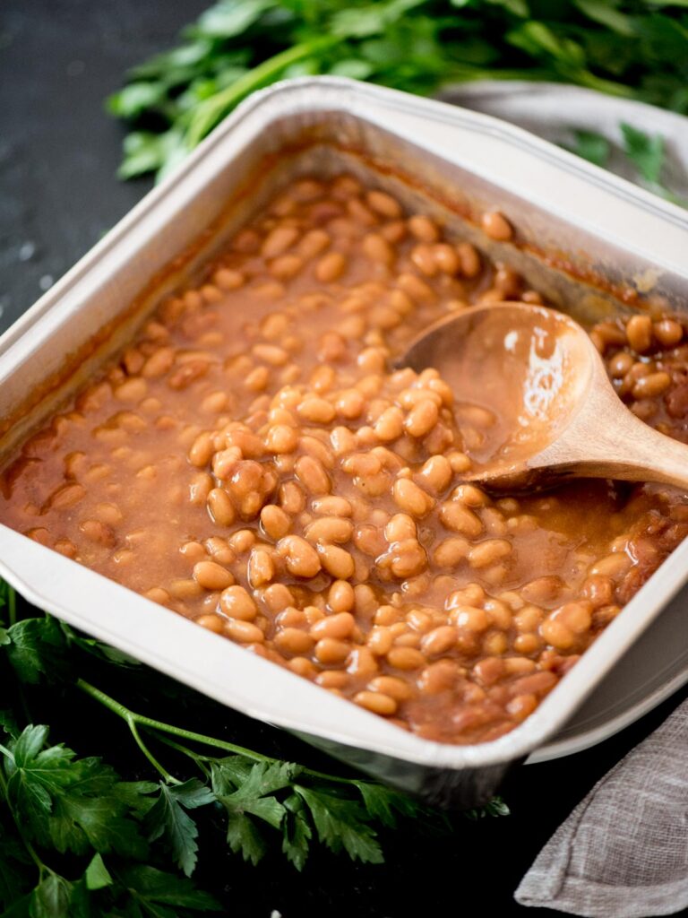 smoked baked beans with a spoon in them