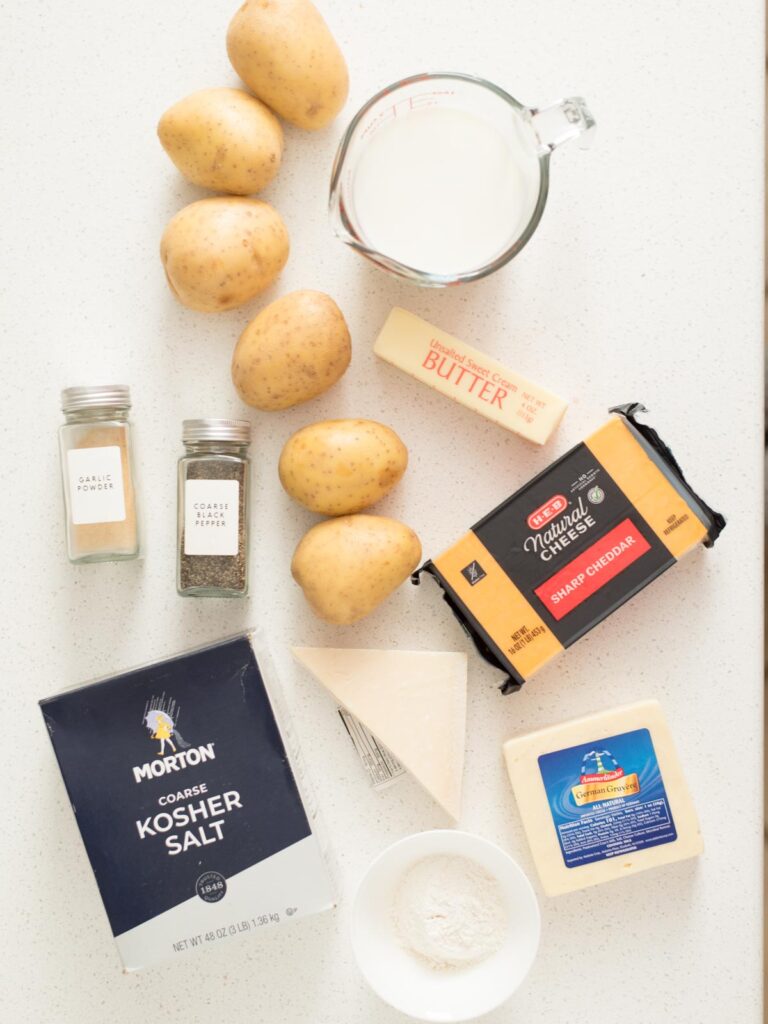Ingredients shown are used to prepare cheesy au gratin potatoes.