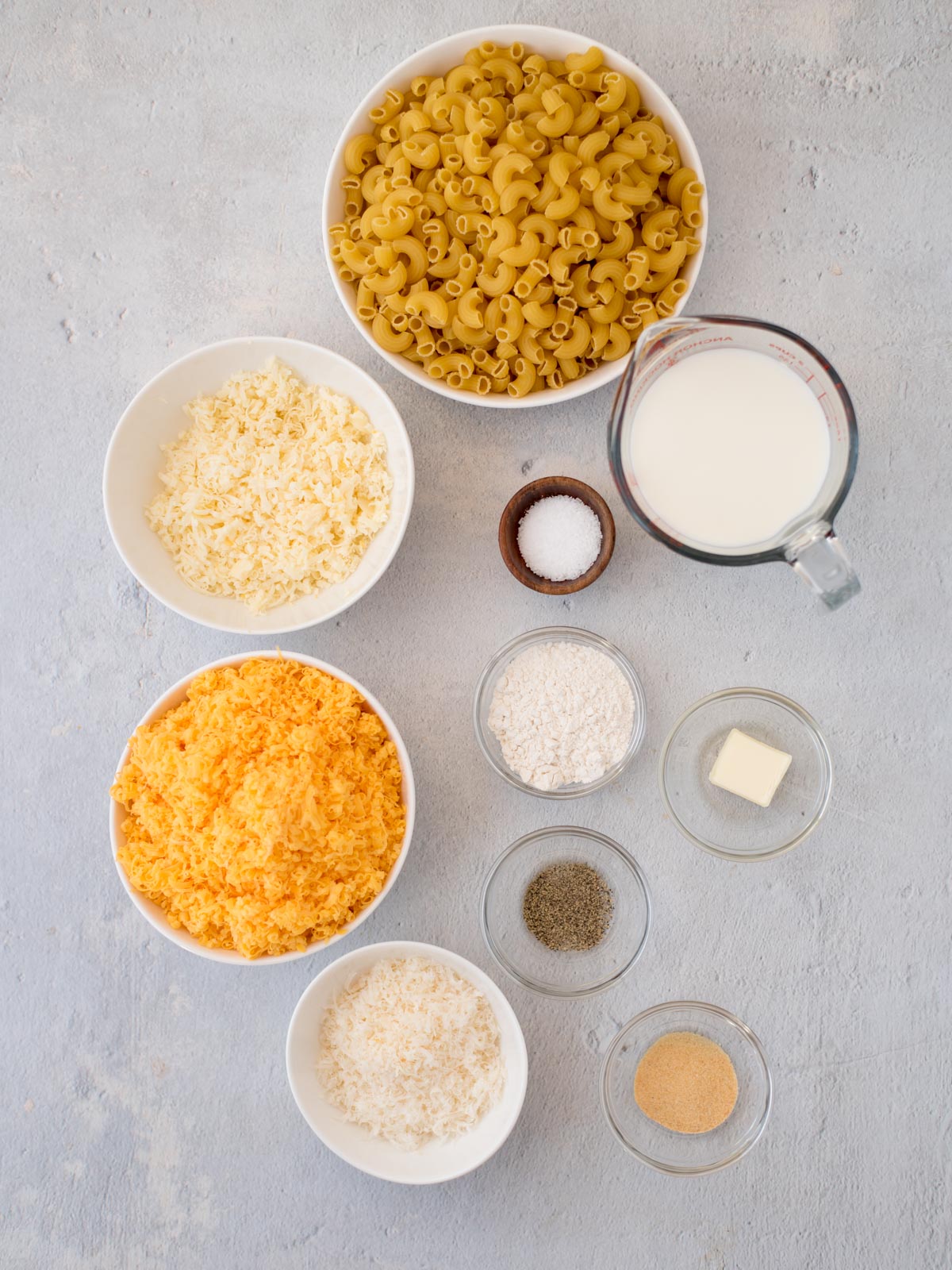 Ingredients shown are used to prepare baked mac and cheese.