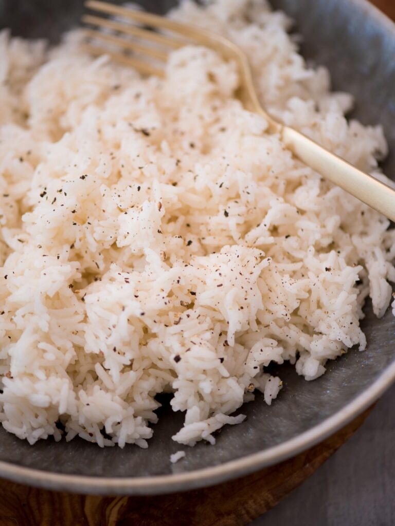 Close up of prepared basmati rice with fresh pepper sprinkled on top.