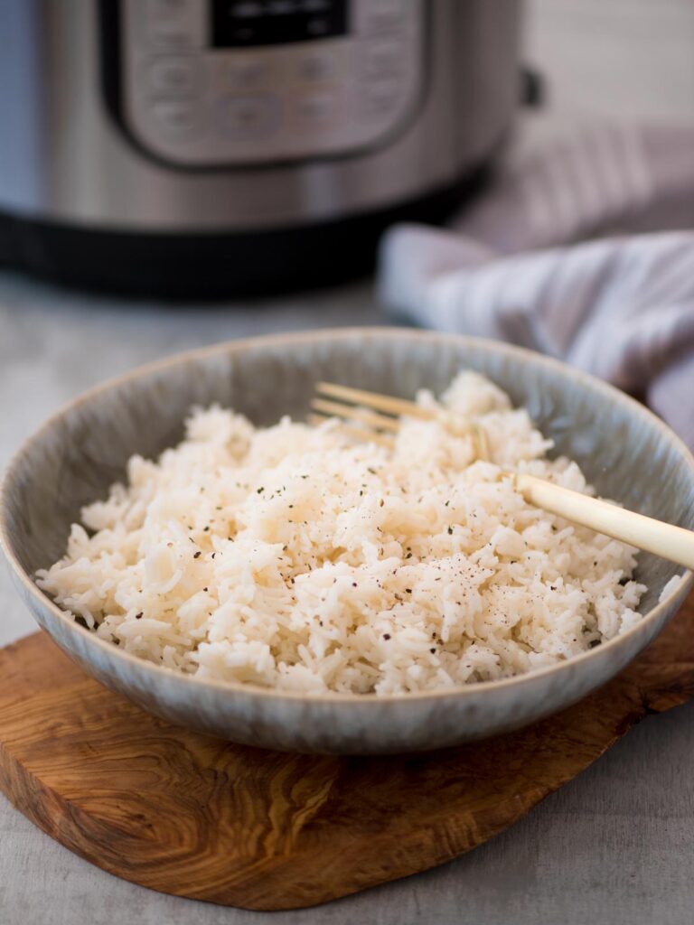 Bowl of basmati rice with a fork inserted into the rice.