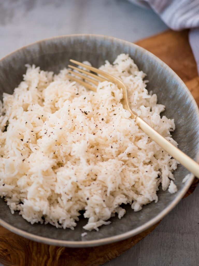 A fork tucked into a bowl of basmati rice that was prepared in the instant pot.