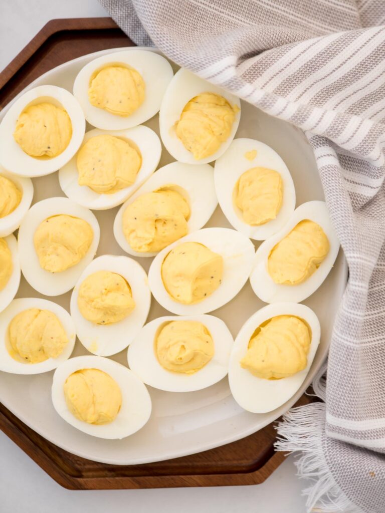 Deviled eggs on a platter without paprika.