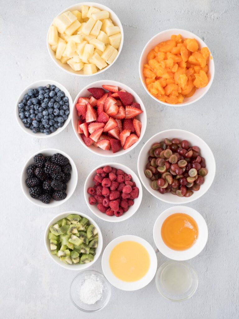 ingredients for fruit salad in individual bowls