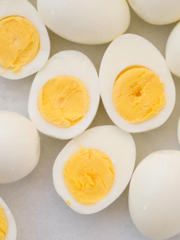 Whole and halved hard boiled eggs.