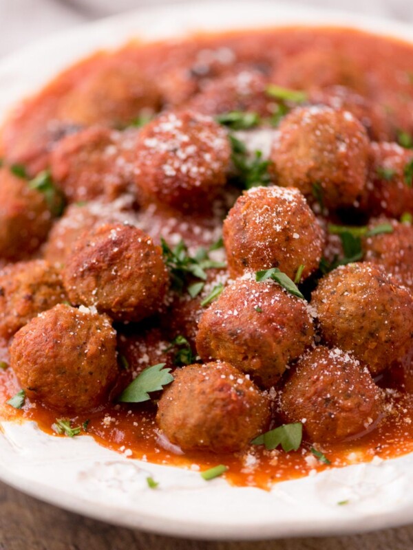 Meatballs in a tomato sauce in a large serving bowl.