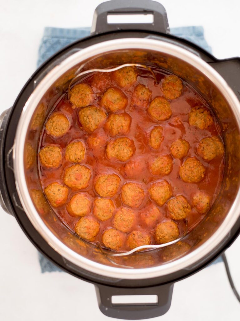 Top view of cooked meatballs in tomato sauce in an instant pot.