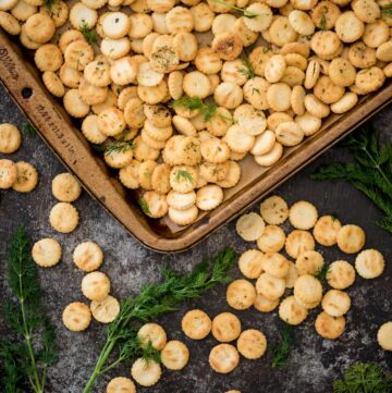 Portion of a baking sheet showing seasoned oyster crackers.