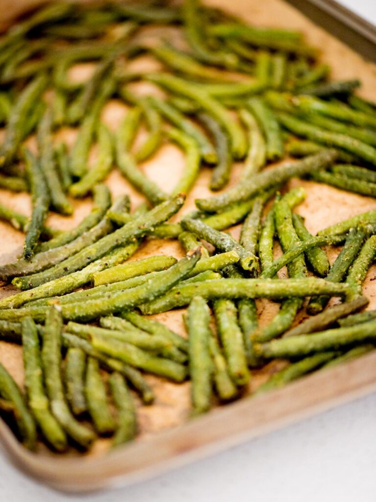 Baking sheet with roasted frozen green beans.