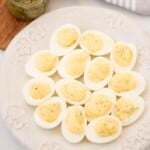 Southern Deviled eggs served on a white decorative serving platter.