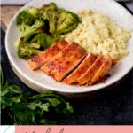 Sliced smoked chicken breasts on a plate with rice and broccoli.