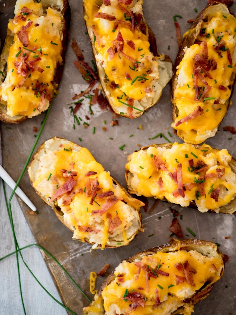 Twice baked potatoes topped with diced bacon.