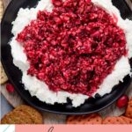 pinterest graphic for cranberry jalapeno dip over cream cheese on a black plate served with crackers
