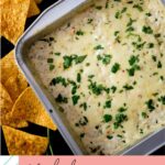 Smoked queso blanco in a baking dish with corn tortilla chips on the side for Pinterest.