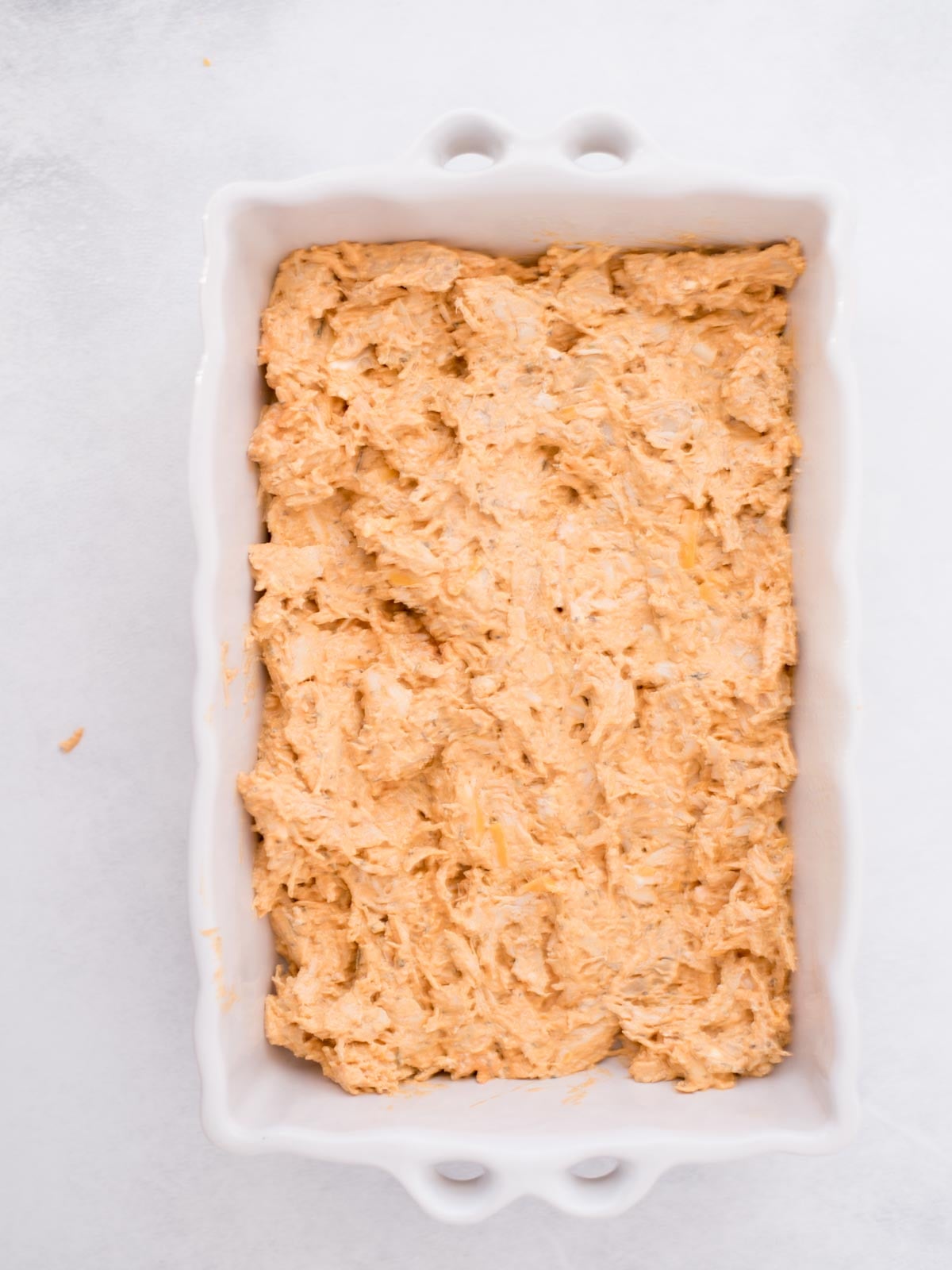 Chicken mixture added to a baking dish.