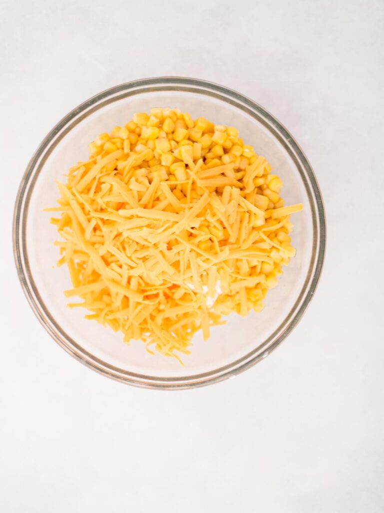 all ingredients in a mixing bowl for corn dip