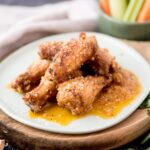 garlic parmesan chicken wings stacked on a light blue plate
