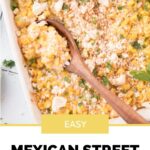 Pinterest image for easy mexican street corn casserole with a wooden spoon laying on top.