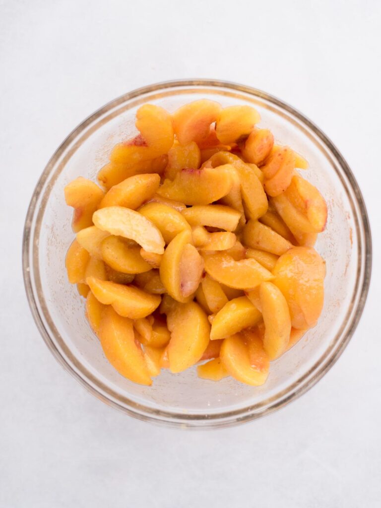 Peaches in a glass bowl.