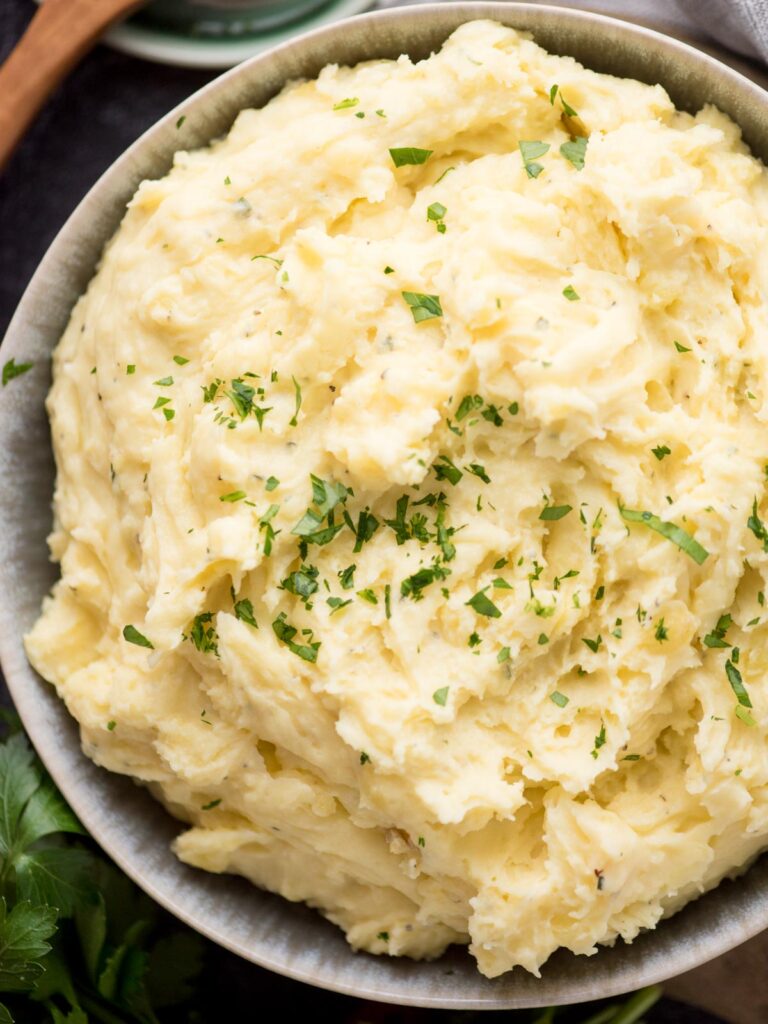 Large serving bowl of boursin mashed potatoes.