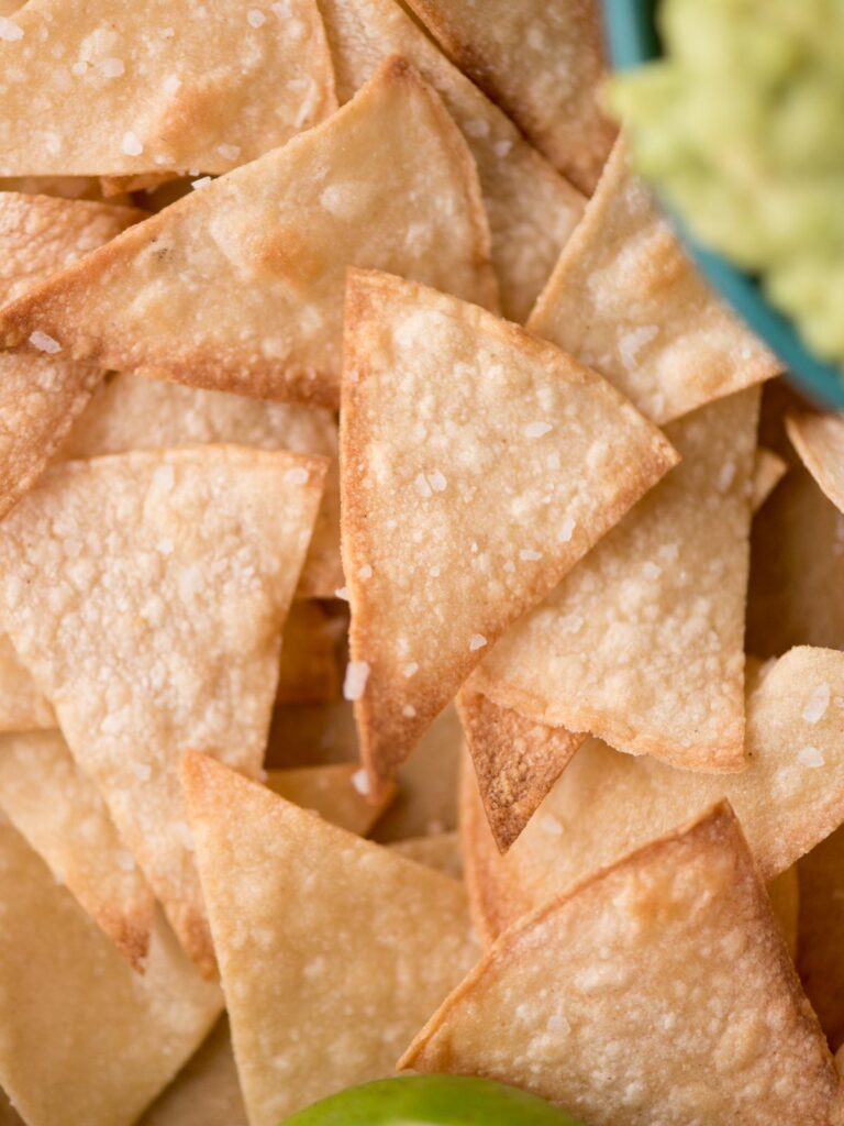 A bunch of salted baked tortilla chips.