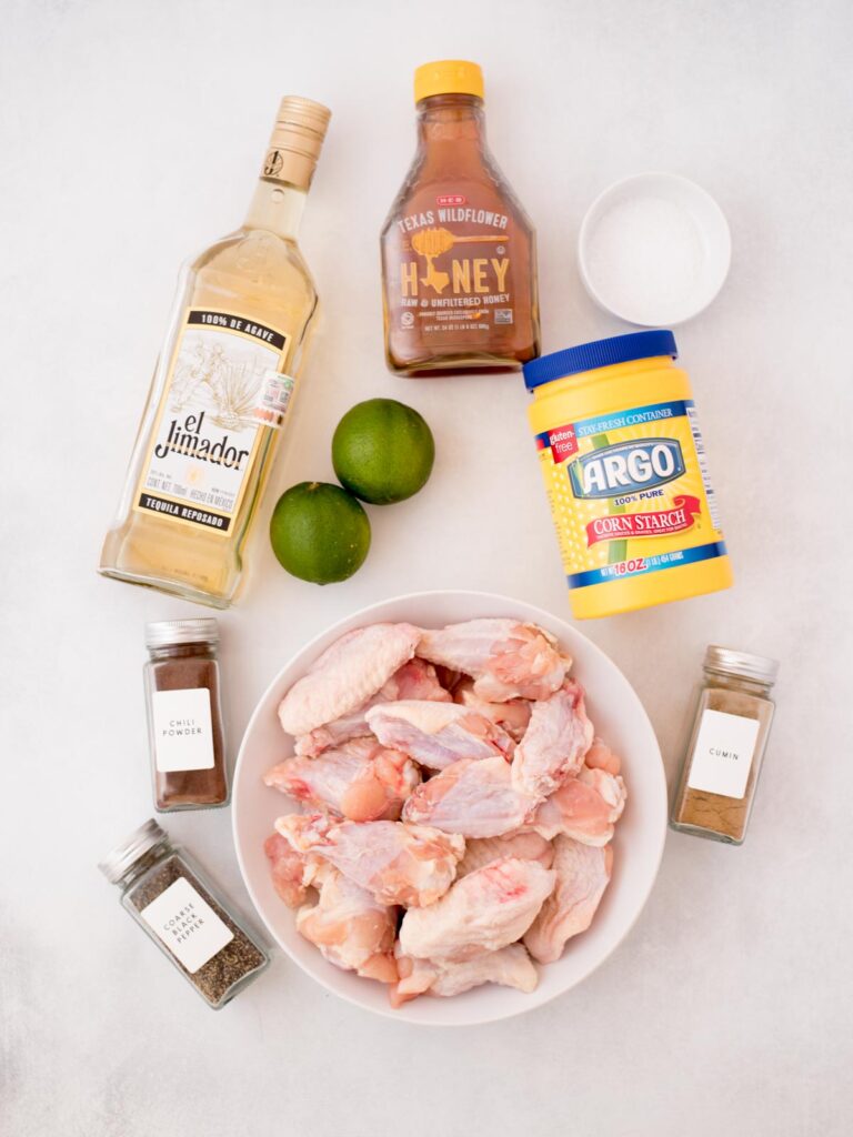 Ingredients shown that are used to prepare baked tequila lime chicken wings.