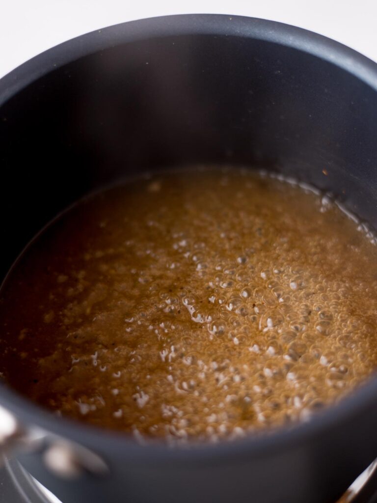 Tequila glaze simmering in a saucepan.