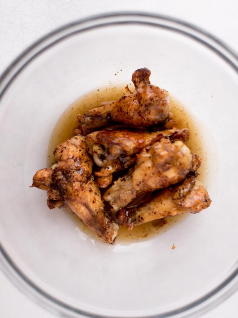 Baked chicken wings in a bowl with a tequila glaze.