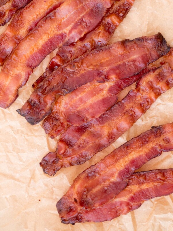 Crispy bacon cooked in the oven on parchment paper.