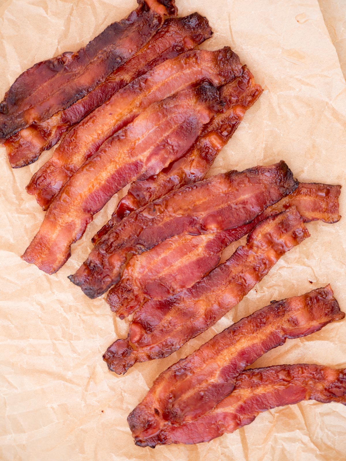 Top view of crispy bacon on parchment paper.