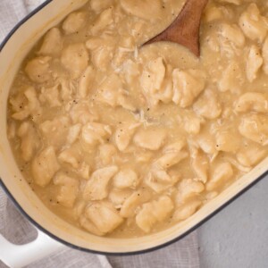 Chicken and dumplings using canned biscuits is cooked and ready to serve in a baking dish.