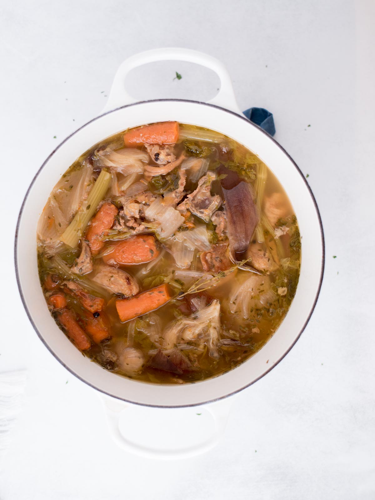 cooked and unstrained chicken broth in a dutch oven