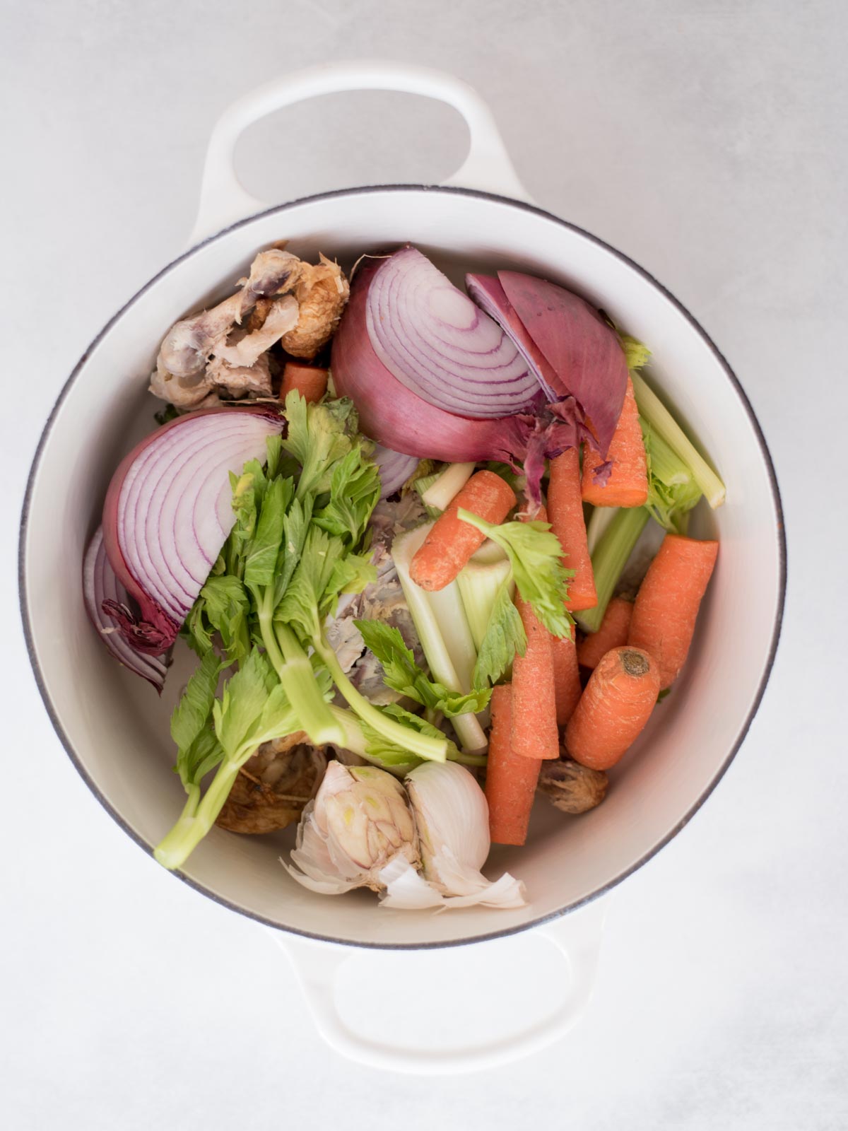 vegetables and chicken scraps in a dutch oven