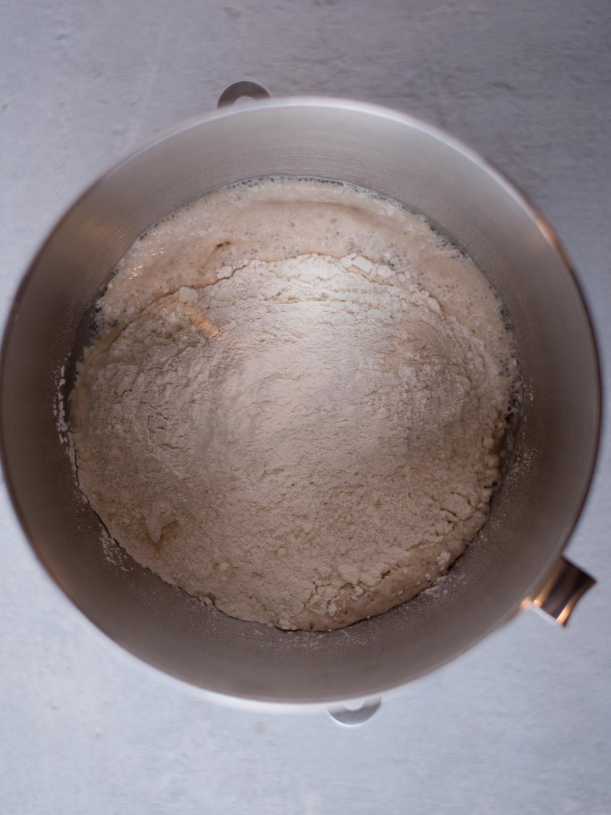 flour added to yeast mixture in mixing bowl