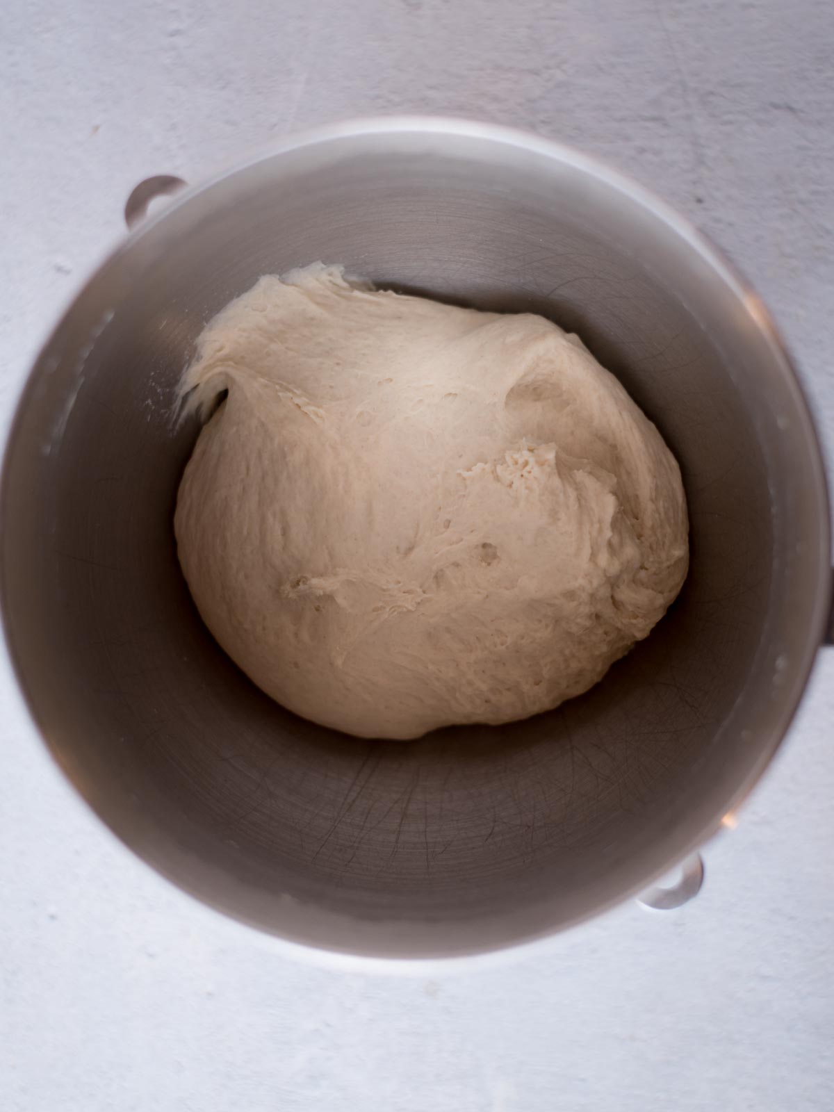 dough in a mixing bowl after its been kneaded