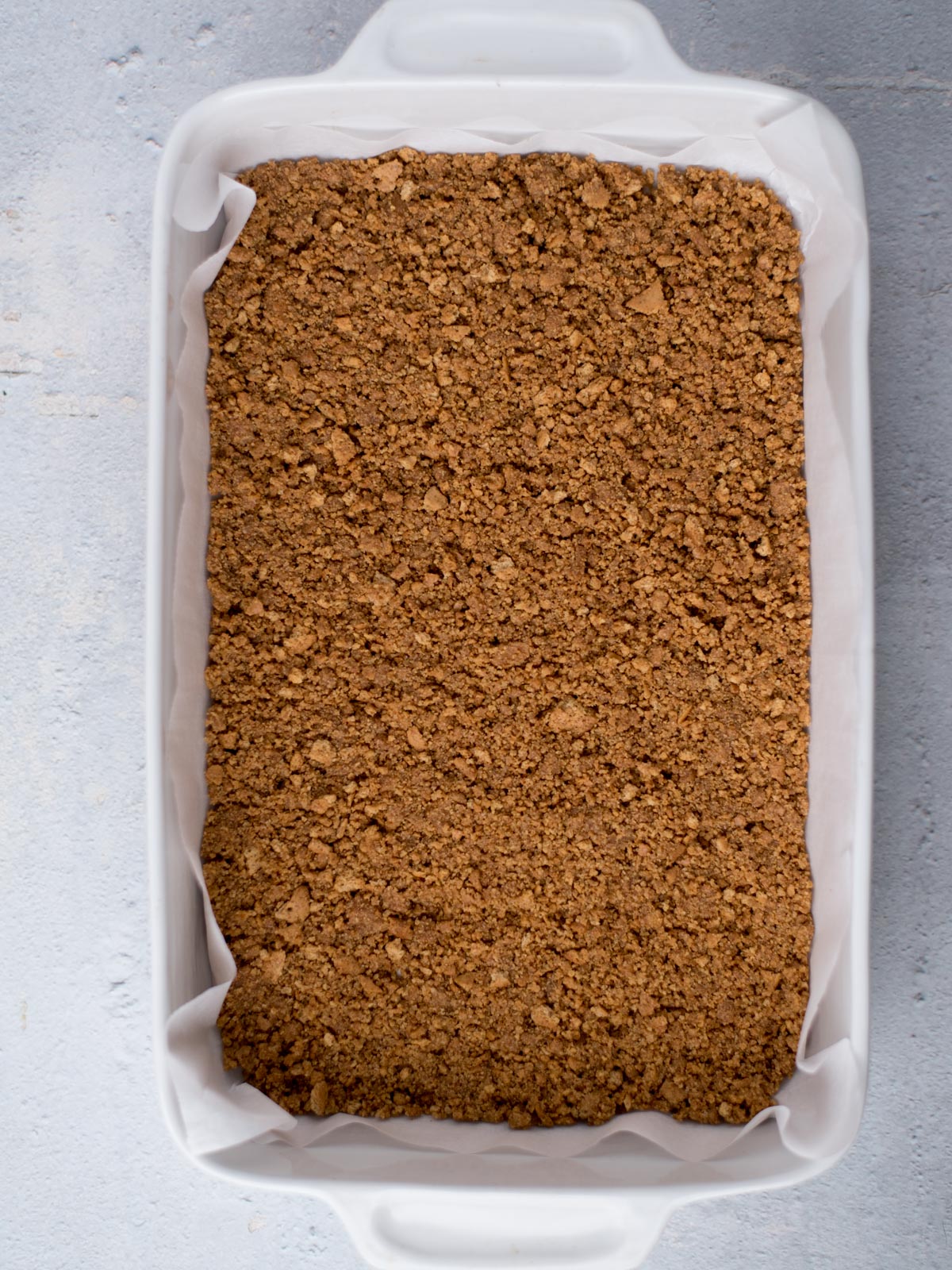 baked graham cracker crust in a 9x13 dish