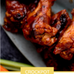 Pinterest image of crockpot barbecue chicken wings on a platter with extra bbq sauce on top.