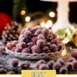 A plate of sugared cranberries sits on a dark surface, surrounded by scattered cranberries. The background is softly lit with bokeh lights and festive decor. The text reads Easy Sugared Cranberries at the bottom and sweetlyspendid.com at the top.