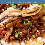 A close-up of shredded barbacoa beef on toasted tortillas, topped with chopped cilantro and diced onions. A blue banner at the top reads slow cooker barbacoa with the website sweetlysplendid.com.