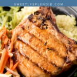 A grilled pork chop on a plate, served with mashed potatoes and a side of shredded vegetables. The image has a blue banner at the top with the text “grilled pork chops” and “sweetlysplendid.com.”.