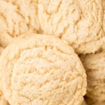 A close-up of soft, round vanilla pudding cookies with a light, fluffy texture. Text at the top reads soft vanilla pudding cookies and sweetlysplendid.com.