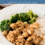 A plate of brown sugar chicken served with white rice and steamed broccoli, placed on a wooden surface. The image includes the text brown sugar chicken and sweetlysplendid.com at the top.