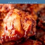 Close-up of glazed grilled chicken thighs stacked on a plate, with text above reading grilled CHICKEN THIGHS and sweetlysplendid.com on a blue background.