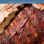 Close-up of smoked ribs with a rich, dark glaze, partially sliced, on parchment paper with parsley garnish. Text overlay reads smoked ribs and sweetlysplendid.com..