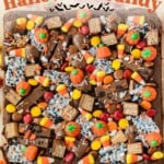 A brownie topped with assorted Halloween candies, including candy corn, pumpkins, and chocolate bars, with text reading How to Use Up Leftover Halloween Candy.