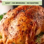 Roasted turkey with herbs on a wooden board, with text overlay: Thanksgiving Turkey Recipe, Easy, No Brining, No Basting.