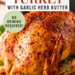 Roasted turkey with garlic herb butter, with text overlay reading Oven roasted turkey with garlic herb butter and No brining required!.