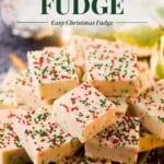 A stack of square sugar cookie fudge pieces topped with red, white, and green sprinkles, with text reading Sugar Cookie FUDGE Easy Christmas Fudge overlaid at the top.