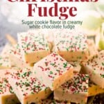 A stack of square sugar cookie fudge pieces made of white chocolate and topped with red, white, and green sprinkles.